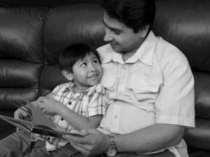 A man reads with his son
