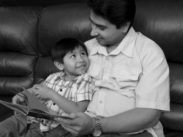 A man reading with his son